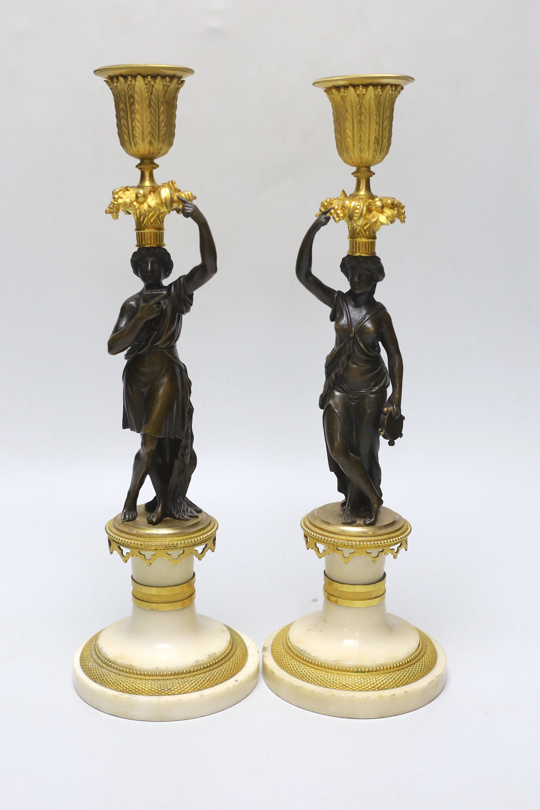 A pair of early 20th century bronze, ormolu and alabaster figural candlesticks, 33cm